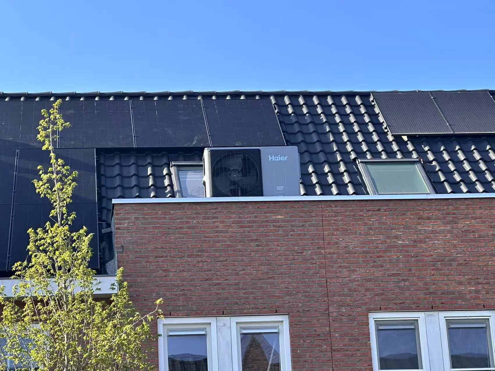 Haier outdoor heat pump unit mounted on a Dutch roof